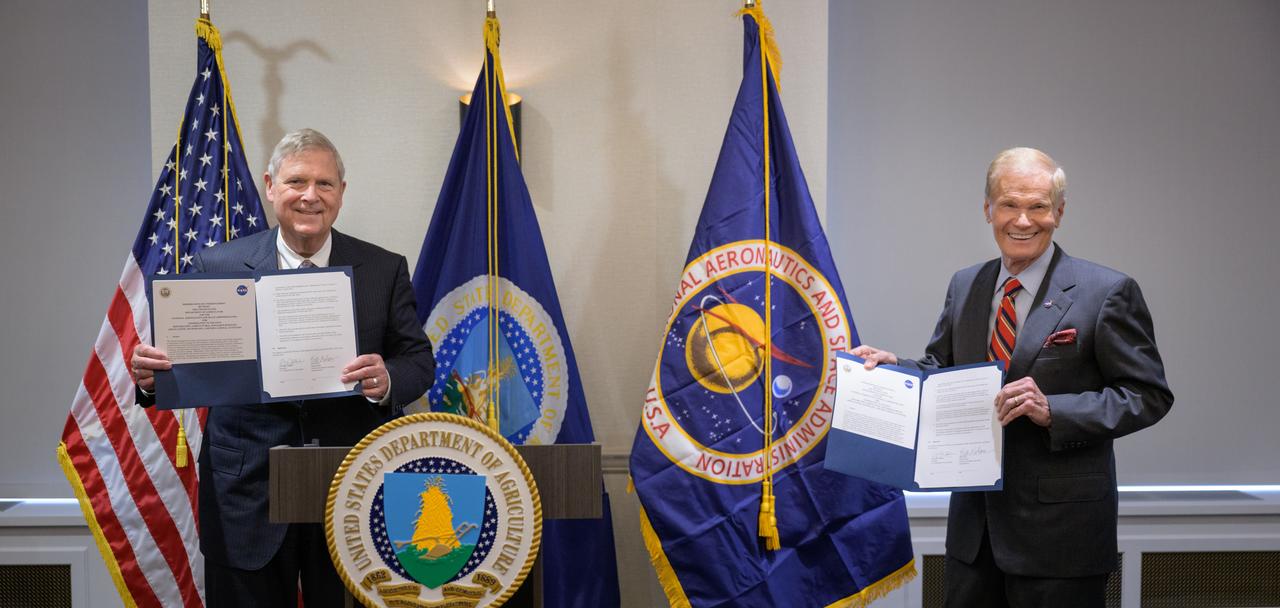 U.S. Secretary of Agriculture Thomas Vilsack, left, and NASA Administrator Bill Nelson, pose for a photograph after having signed a memorandum of understanding, Wednesday, June 21, 2023, at the USDA’s Jamie L. Whitten Building in Washington. The agreement strengthens the collaboration between the two agencies, including efforts to improve agricultural and Earth science research, technology, and agricultural management, as well as the application of science data and models to agricultural decision making. Photo Credit: (NASA/Bill Ingalls)