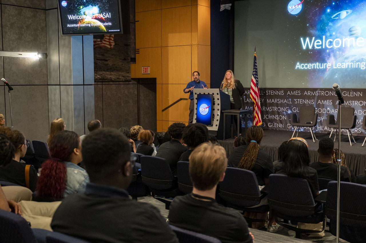 Principal Systems Engineer Michael Chyatte, left, and Project Manager Nicole Ramberg-Pihl, right, deliver remarks regarding the new Earth Information Center (EIC) during a high school student engagement event, Thursday, July 6, 2023, at the Mary W. Jackson NASA Headquarters building in Washington. Photo Credit: (NASA/Keegan Barber)