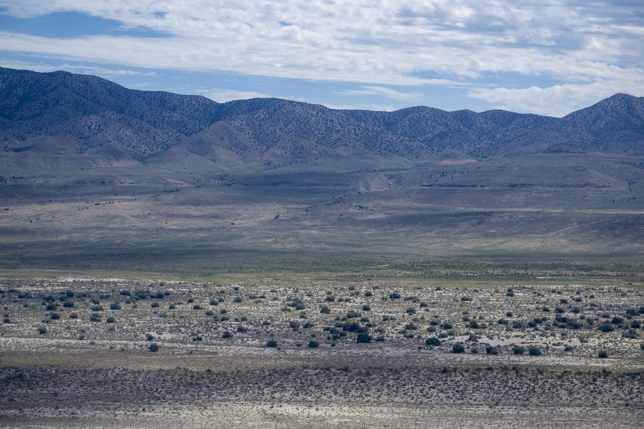 The Department of Defense's Utah Test and Training Range is seen from the cockpit of a helicopter, Wednesday, July 19, 2023, as recovery teams participate in helicopter training in preparation for the retrieval of the sample return capsule from NASA's OSIRIS-REx mission. The sample was collected from the asteroid Bennu in October 2020 by NASA’s OSIRIS-REx spacecraft and will return to Earth on September 24th, landing under parachute at the Utah Test and Training Range. Photo Credit: (NASA/Keegan Barber)