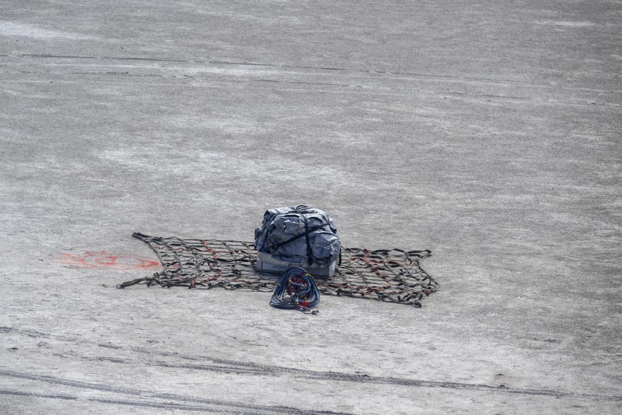 A training model of the sample return capsule is seen from the cockpit of a helicopter as recovery teams participate training in preparation for the retrieval of the sample return capsule from NASA's OSIRIS-REx mission, Wednesday, July 19, 2023, at the Department of Defense's Utah Test and Training Range. The sample was collected from the asteroid Bennu in October 2020 by NASA’s OSIRIS-REx spacecraft and will return to Earth on September 24th, landing under parachute at the Utah Test and Training Range. Photo Credit: (NASA/Keegan Barber)