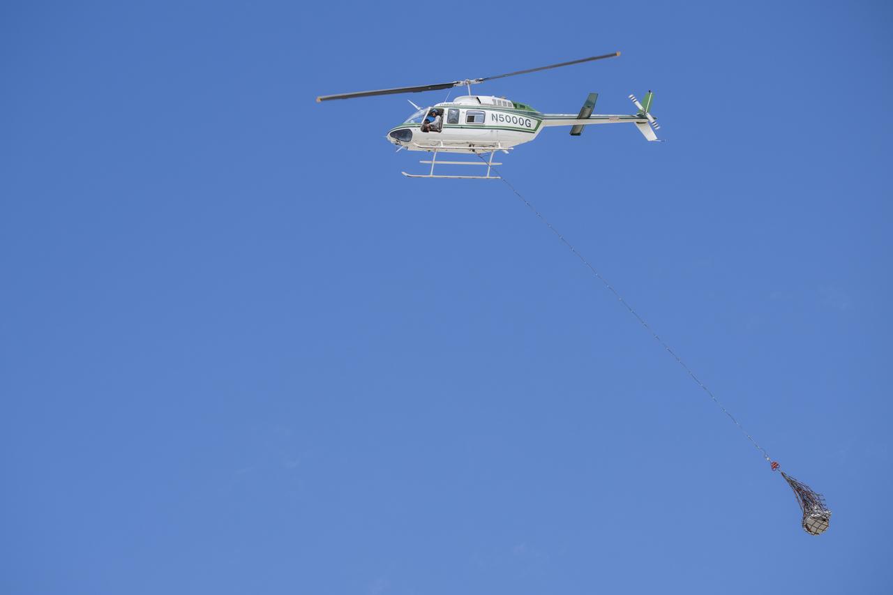 Recovery teams participate in helicopter training in preparation for the retrieval of the sample return capsule from NASA's OSIRIS-REx mission, Wednesday, July 19, 2023, at the Department of Defense's Utah Test and Training Range. The sample was collected from the asteroid Bennu in October 2020 by NASA’s OSIRIS-REx spacecraft and will return to Earth on September 24th, landing under parachute at the Utah Test and Training Range. Photo Credit: (NASA/Keegan Barber)