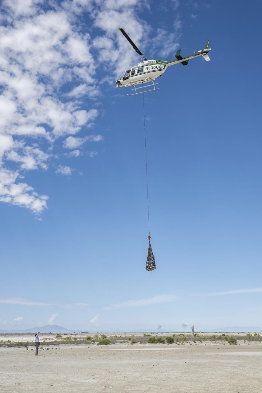 Recovery teams participate in helicopter training in preparation for the retrieval of the sample return capsule from NASA's OSIRIS-REx mission, Wednesday, July 19, 2023, at the Department of Defense's Utah Test and Training Range. The sample was collected from the asteroid Bennu in October 2020 by NASA’s OSIRIS-REx spacecraft and will return to Earth on September 24th, landing under parachute at the Utah Test and Training Range. Photo Credit: (NASA/Keegan Barber)