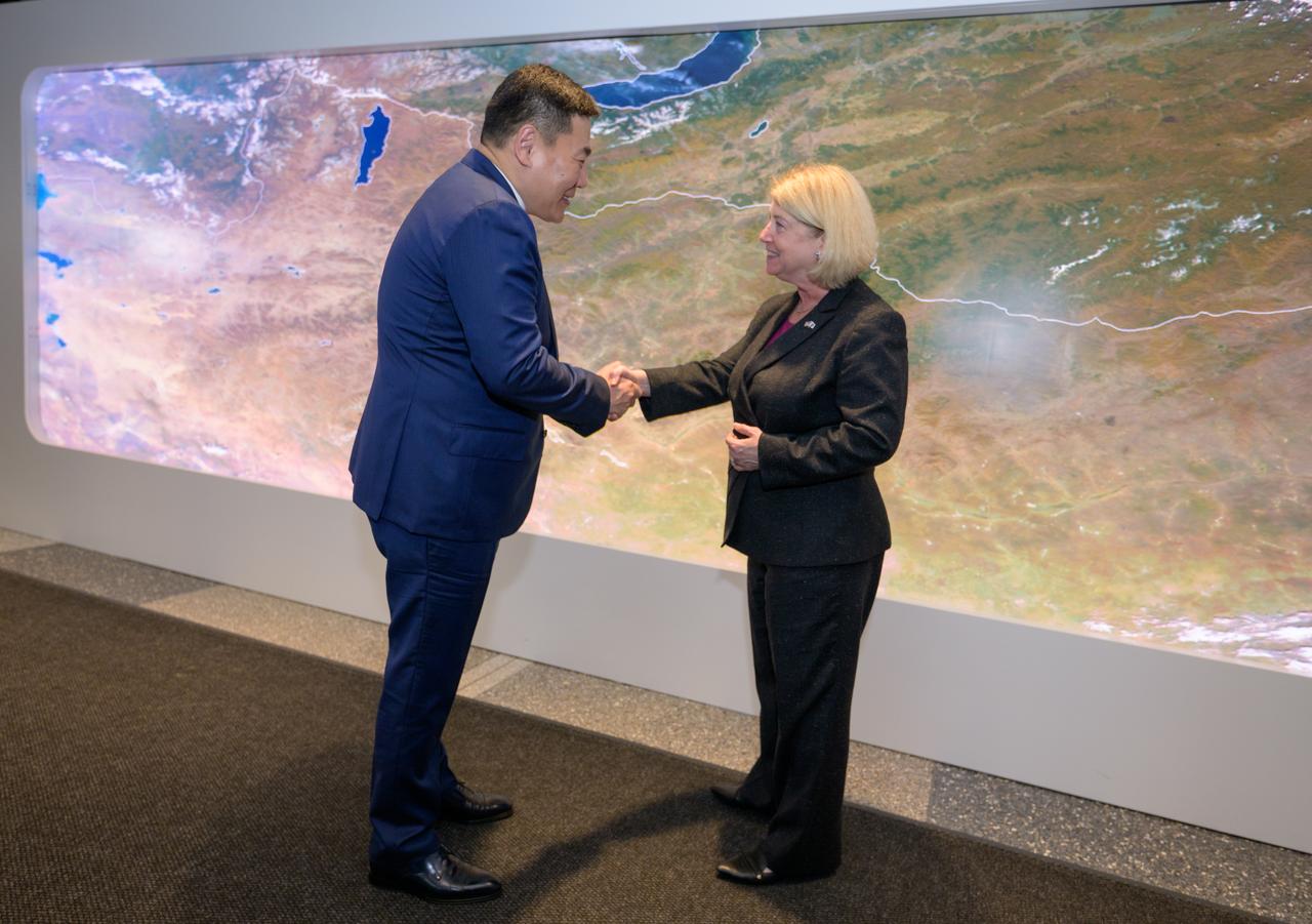 Prime Minister Oyun-Erdene Luvsannamsrai of Mongolia, left, and NASA Deputy Administrator Pam Melroy shake hands at the conclusion of meeting and touring NASA’s Earth Information Center, Friday, Aug. 4, 2023, at the NASA Headquarters Mary W. Jackson Building in Washington. The Earth Information Center is a new immersive experience that combines live data sets with cutting-edge data visualization to show NASA data can improve lives in the face of disasters, environmental challenges, and our changing world. Photo Credit: (NASA/Bill Ingalls)