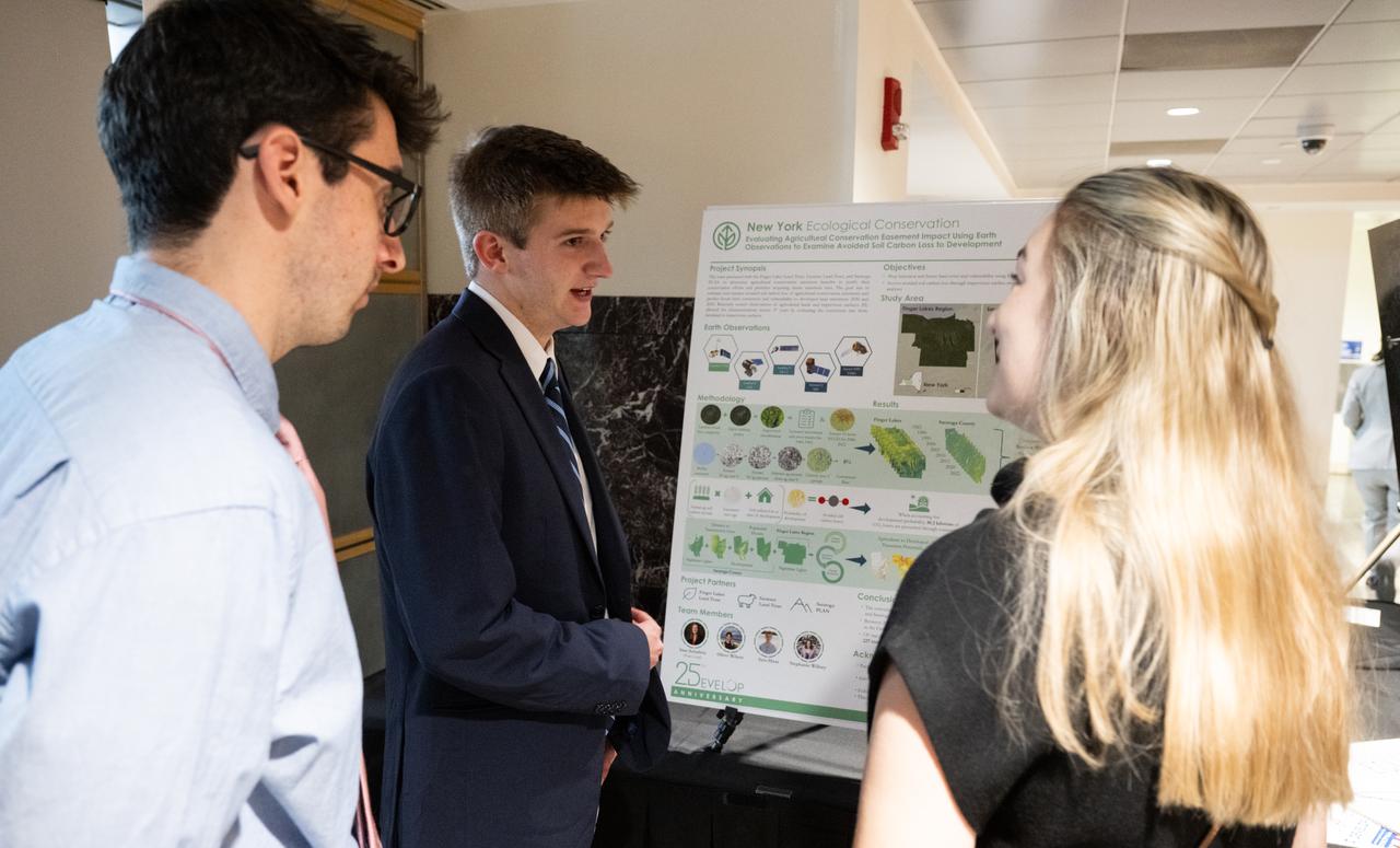 Students and young professionals discuss their projects during the 2023 DEVELOP Day, Wednesday, Aug. 9, 2023, at the Mary W. Jackson NASA Headquarters building in Washington. Every summer students and young professionals from NASA’s Applied Sciences’ DEVELOP National Program come to NASA Headquarters to present their research. This year marks the 25th year of DEVELOP, a training and development program where students work on Earth science research projects, mentored by science advisors from NASA and partner agencies, and extend research results to local communities. Photo Credit: (NASA/Joel Kowsky)