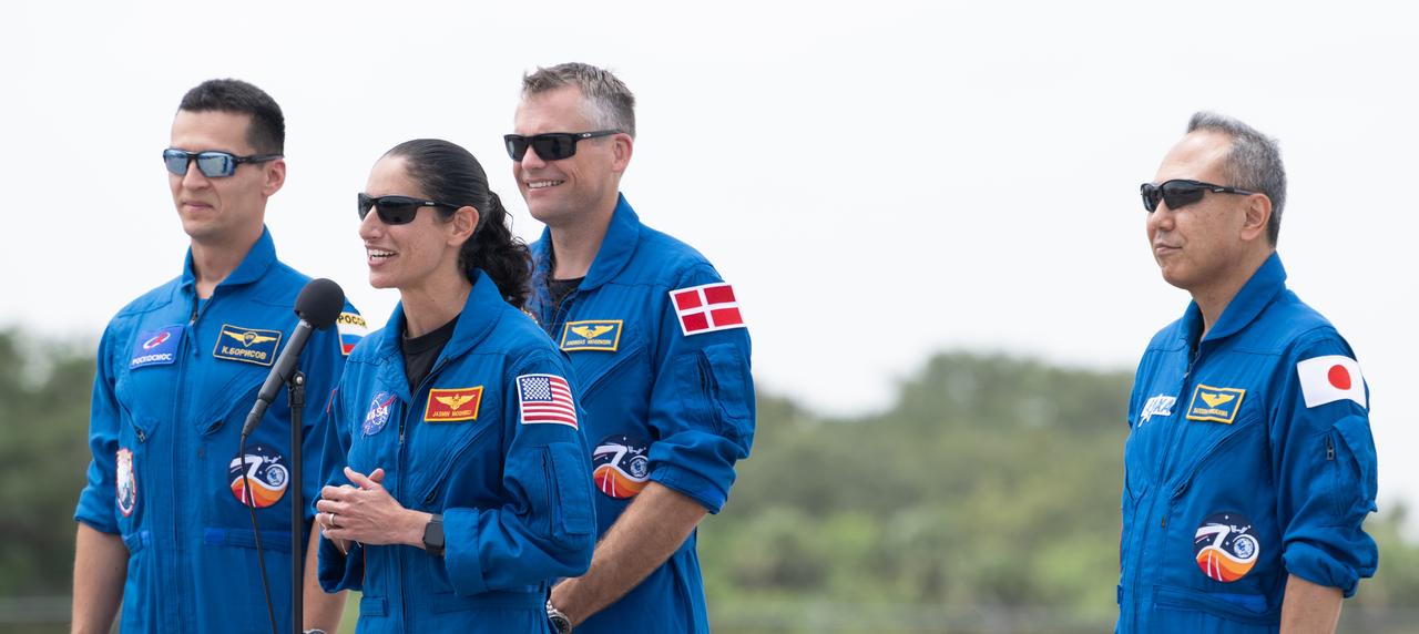 NASA astronaut Jasmin Moghbeli, second from right, answers a question from a member of the media along side fellow crewmates Roscosmos cosmonaut Konstantin Borisov, ESA (European Space Agency) astronaut Andreas Mogensen, and Japan Aerospace Exploration Agency (JAXA) astronaut Satoshi Furukawa, after arriving at the Launch and Landing Facility at NASA’s Kennedy Space Center in Florida ahead of the agency’s SpaceX Crew-7 mission, Sunday, Aug. 20, 2023. NASA’s SpaceX Crew-7 mission is the seventh crew rotation mission of the SpaceX Dragon spacecraft and Falcon 9 rocket to the International Space Station as part of the agency’s Commercial Crew Program. Moghbeli, Mogensen, Furukawa, and Borisov are scheduled to launch at 3:49 a.m. EDT on August 25, from Launch Complex 39A at the Kennedy Space Center. Photo Credit: (NASA/Joel Kowsky)
