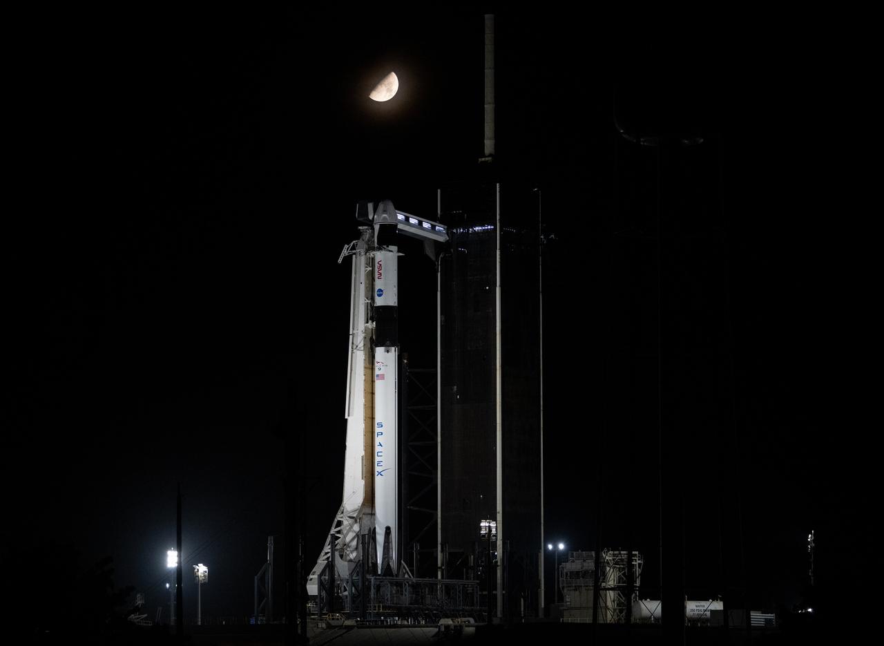 The Moon is seen over a SpaceX Falcon 9 rocket with the company's Dragon spacecraft on top is seen on the launch pad at Launch Complex 39A, Thursday, Aug. 24, 2023, at NASA’s Kennedy Space Center in Florida. NASA’s SpaceX Crew-7 mission is the seventh crew rotation mission of the SpaceX Crew Dragon spacecraft and Falcon 9 rocket to the International Space Station as part of the agency’s Commercial Crew Program. NASA astronaut Jasmin Moghbeli, ESA (European Space Agency) astronaut Andreas Mogensen, Japan Aerospace Exploration Agency (JAXA) astronaut Satoshi Furukawa, and Roscosmos cosmonaut Konstantin Borisov are scheduled to launch at 3:27 a.m. EDT on Saturday, August 26, from Launch Complex 39A at the Kennedy Space Center. Photo Credit: (NASA/Joel Kowsky)