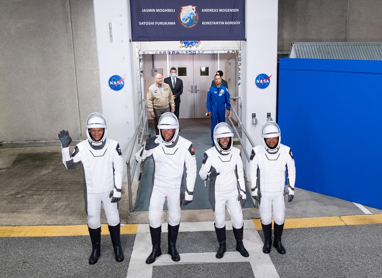 Roscosmos cosmonaut Konstantin Borisov, left, ESA (European Space Agency) astronaut Andreas Mogensen, second from left, NASA astronaut Jasmin Moghbeli, second from right, and Japan Aerospace Exploration Agency (JAXA) astronaut Satoshi Furukawa, right,  wearing SpaceX spacesuits, are seen as they prepare to depart the Neil  A. Armstrong Operations and Checkout Building for Launch Complex 39A to board the SpaceX Dragon spacecraft for the Crew-7 mission launch, Saturday, Aug. 26, 2023, at NASA’s Kennedy Space Center in Florida. NASA’s SpaceX Crew-7 mission is the seventh crew rotation mission of the SpaceX Crew Dragon spacecraft and Falcon 9 rocket to the International Space Station as part of the agency’s Commercial Crew Program. Moghbeli, Mogensen, Furukawa, and Borisov are scheduled to launch at 3:27 a.m. EDT from Launch Complex 39A at the Kennedy Space Center.  Photo Credit: (NASA/Joel Kowsky)