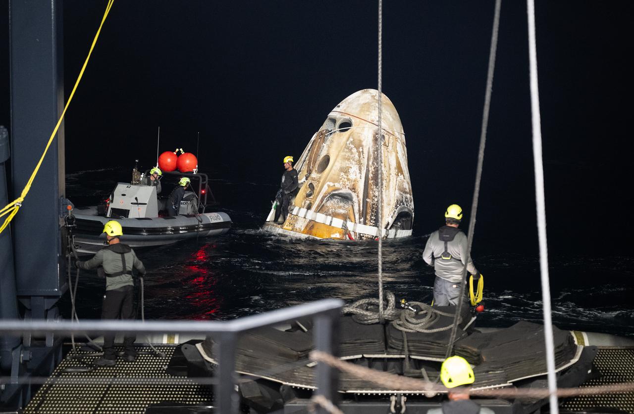 Support teams work around the SpaceX Dragon Endeavour spacecraft shortly after it landed with NASA astronauts Stephen Bowen and Warren "Woody" Hoburg, UAE (United Arab Emirates) astronaut Sultan Alneyadi, and Roscosmos cosmonaut Andrey Fedyaev aboard in the Atlantic Ocean off the coast of Jacksonville, Florida, Monday, Sept. 4,2023. Bowen, Hoburg, Alneyadi, and Fedyaev are returning after nearly six-months in space as part of Expedition 69 aboard the International Space Station. Photo Credit: (NASA/Joel Kowsky)