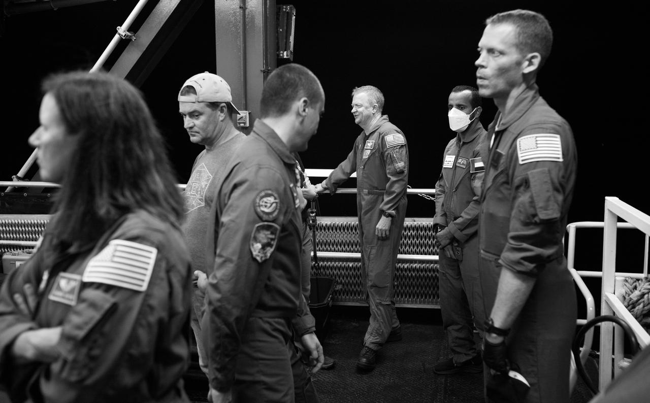 NASA astronauts Shannon Walker, left, Eric Boe, center, Roscosmos cosmonaut Petr Dubrov, third from right, UAE (United Arab Emirates) Hazzaa Ali Almansoori, second from left, and NASA flight surgeon James Pavela, left, are seen as SpaceX recovery teams perform final checks before opening the hatch of the SpaceX Dragon Endeavour spacecraft aboard the recovery ship MEGAN shortly after it landed with NASA astronauts Stephen Bowen and Warren "Woody" Hoburg, UAE (United Arab Emirates) astronaut Sultan Alneyadi, and Roscosmos cosmonaut Andrey Fedyaev aboard in theAtlantic Ocean off the coast of Jacksonville, Florida, Monday, Sept. 4, 2023. Bowen, Hoburg, Alneyadi, and Fedyaev are returning after nearly six-months in space as part of Expedition 69 aboard the International Space Station. Photo Credit: (NASA/Joel Kowsky)