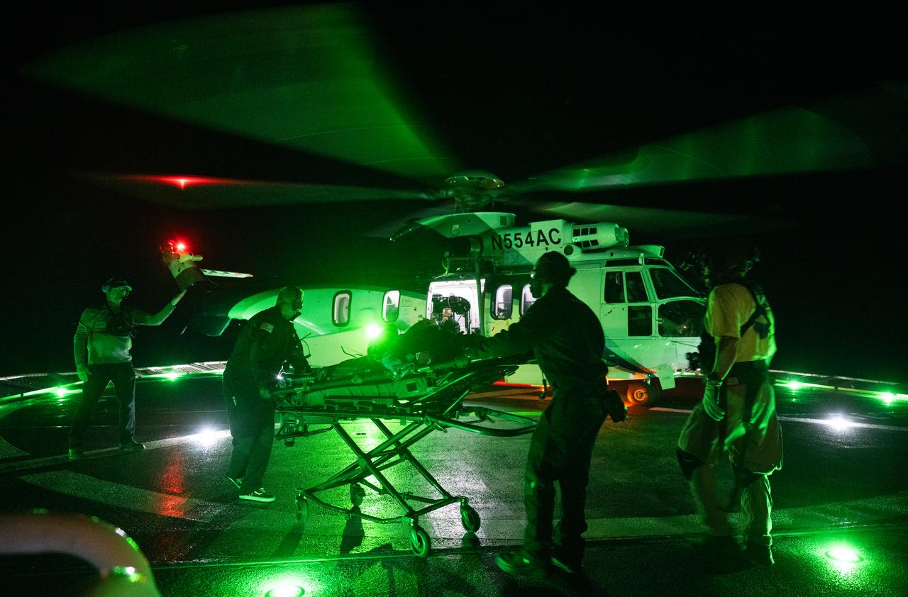 NASA astronaut Stephen Bowen is helped aboard a helicopter on the SpaceX recovery ship MEGAN to fly to Jacksonville, Florida with NASA astronaut Warren "Woody" Hoburg, UAE (United Arab Emirates) astronaut Sultan Alneyadi, and Roscosmos cosmonaut Andrey Fedyaev a few hours after they landed in their SpaceX Dragon Endeavour  in the Atlantic Ocean, Monday, Sept. 4, 2023. Bowen, Hoburg, Alneyadi, and Fedyaev are returning after nearly six-months in space as part of Expedition 69 aboard the International Space Station. Photo Credit: (NASA/Joel Kowsky)