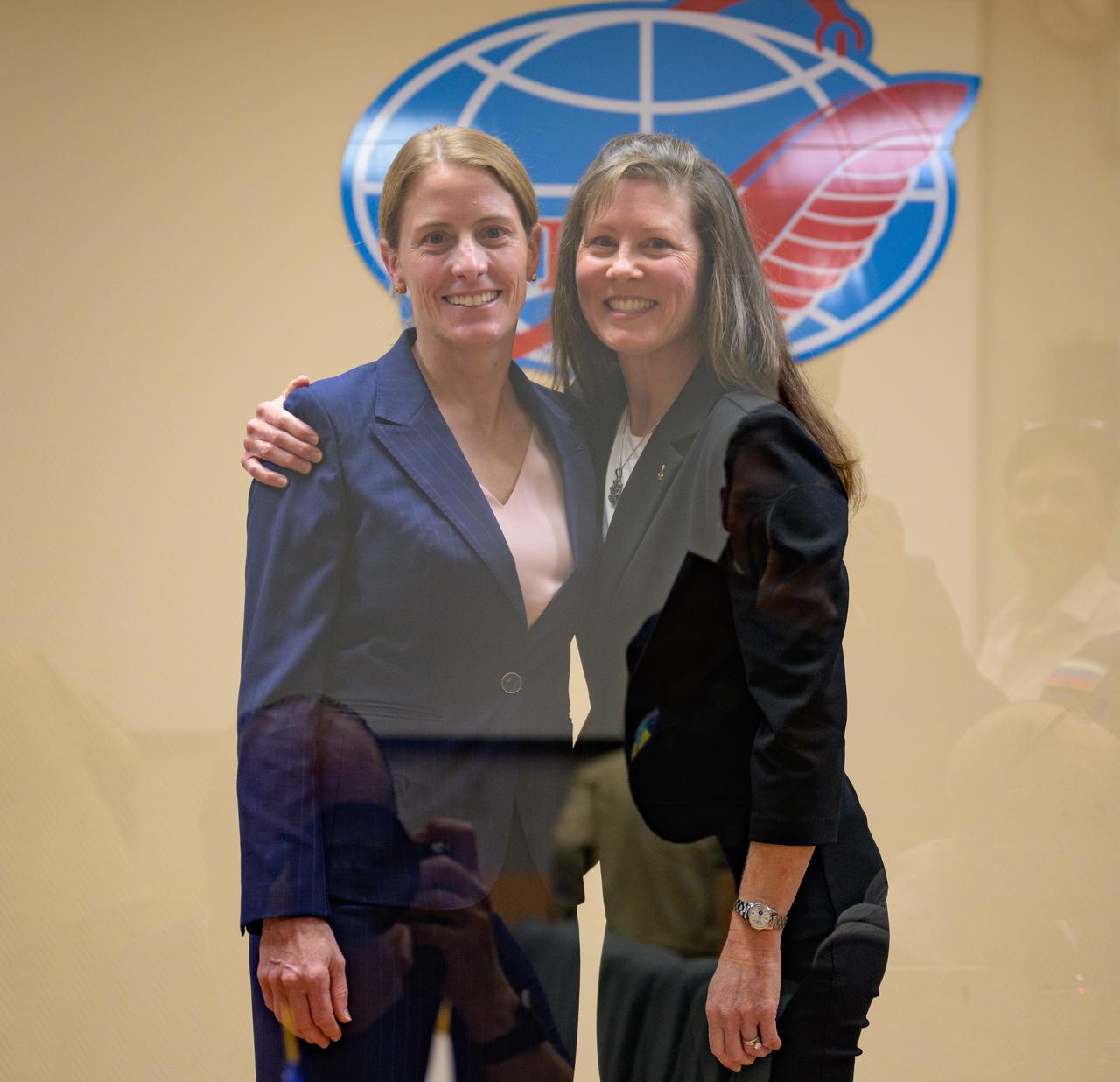 Expedition 70 prime crew NASA astronaut Loral O'Hara, left, and backup crew member NASA astronaut Tracy Dyson pose for a photograph while in quarantine behind glass during the State Commission meeting to approve the Soyuz launch of Expedition 70 to the international Space Station, Thursday, Sept. 14, 2023 at the Cosmonaut Hotel in Baikonur, Kazakhstan. Photo Credit: (NASA/Bill Ingalls)