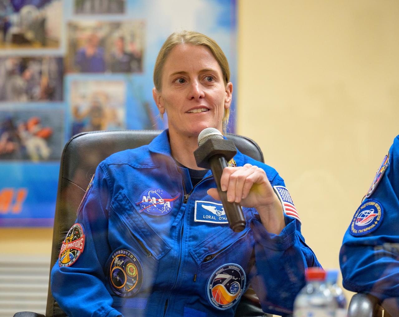 Expedition 70 astronaut Loral O'Hara is seen in quarantine behind glass during a press conference, Thursday, Sept. 14, 2023 at the Cosmonaut Hotel in Baikonur, Kazakhstan. Expedition 70 NASA astronaut Loral O'Hara, Roscosmos cosmonauts Oleg Kononenko, and Nikolai Chub are scheduled to launch aboard their Soyuz MS-24 spacecraft on Sept. 15. Photo Credit: (NASA/Bill Ingalls)