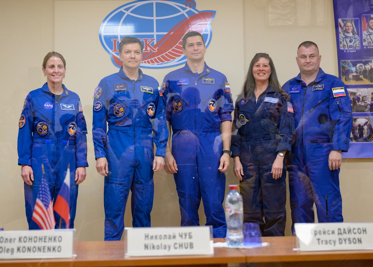 Expedition 70 prime crew NASA astronaut Loral O'Hara, left, Roscosmos cosmonauts Oleg Kononenko, and Nikolai Chub, along with backup crew members Tracy Dyson and Alexey Ovchinin, right, pose for a group photograph while in quarantine behind glass during a press conference, Thursday, Sept. 14, 2023 at the Cosmonaut Hotel in Baikonur, Kazakhstan. O'Hara, Kononenko, and Chub are scheduled to launch aboard their Soyuz MS-24 spacecraft on Sept. 15. Photo Credit: (NASA/Bill Ingalls)