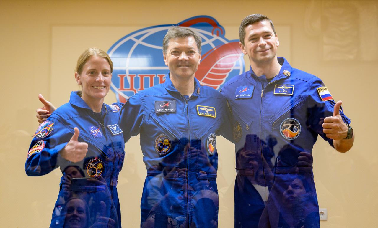 Expedition 70 NASA astronaut Loral O'Hara, left, Roscosmos cosmonauts Oleg Kononenko, and Nikolai Chub, right, pose for a group photograph while in quarantine behind glass during a press conference, Thursday, Sept. 14, 2023 at the Cosmonaut Hotel in Baikonur, Kazakhstan. O'Hara, Kononenko, and Chub are scheduled to launch aboard their Soyuz MS-24 spacecraft on Sept. 15. Photo Credit: (NASA/Bill Ingalls)