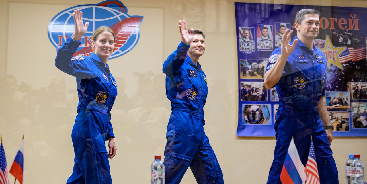 Expedition 70 NASA astronaut Loral O'Hara, left, Roscosmos cosmonauts Oleg Kononenko, and Nikolai Chub, right, wave farewell at the conclusion of a press conference, Thursday, Sept. 14, 2023 at the Cosmonaut Hotel in Baikonur, Kazakhstan. O'Hara, Kononenko, and Chub are scheduled to launch aboard their Soyuz MS-24 spacecraft on Sept. 15. Photo Credit: (NASA/Bill Ingalls)