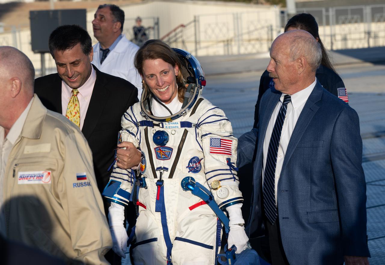 Expedition 70 crew member NASA astronaut Loral O’Hara walks with NASA International Space Station program manager Joel Montalbano, left and Ken Bowersox, associate administrator for NASA's Space Operations Mission Directorate, right, prior to boarding the Soyuz MS-24 spacecraft for launch with fellow crewmates Roscosmos cosmonauts Nikolai Chub and Oleg Kononenko, Friday, Sept. 15, 2023 at the Baikonur Cosmodrome in Kazakhstan. Launch of the Soyuz rocket will send the trio on a mission to the International Space Station. Photo Credit: (NASA/Bill Ingalls)
