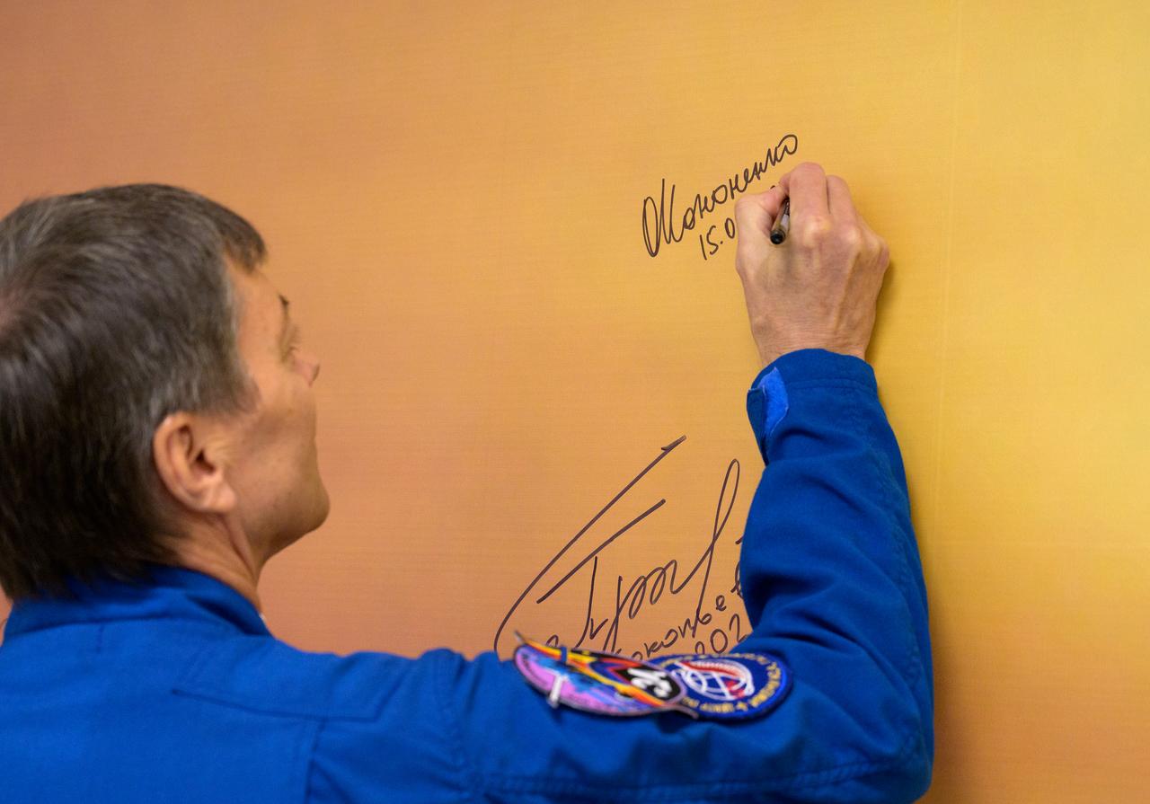 Expedition 70 Roscosmos cosmonaut Oleg Kononenko signs a mural at the Cosmonaut Hotel prior to departing the hotel for launch on a Soyuz rocket with fellow crewmates NASA astronaut Loral O'Hara and Roscosmos cosmonaut Nikolai Chub, Friday, Sept. 15, 2023, in Baikonur, Kazakhstan. The launch will send Expedition 70 NASA astronaut Loral O'Hara and Roscosmos cosmonauts Oleg Kononenko and Nikolai Chub on a mission to the International Space Station. Photo Credit: (NASA/Bill Ingalls)