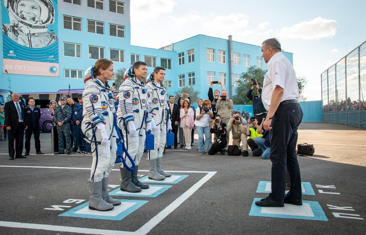Expedition 70 NASA astronaut Loral O'Hara, left, and Roscosmos cosmonauts Oleg Kononenko, center, and Nikolai Chub, meet with official prior to departing building 254 for their Soyuz launch to the International Space Station Friday, Sept. 15, 2023 in Baikonur, Kazakhstan. The launch will send Expedition 70 NASA astronaut Loral O'Hara and Roscosmos cosmonauts Oleg Kononenko and Nikolai Chub on a mission to the International Space Station. Photo Credit: (NASA/Victor Zelentsov)