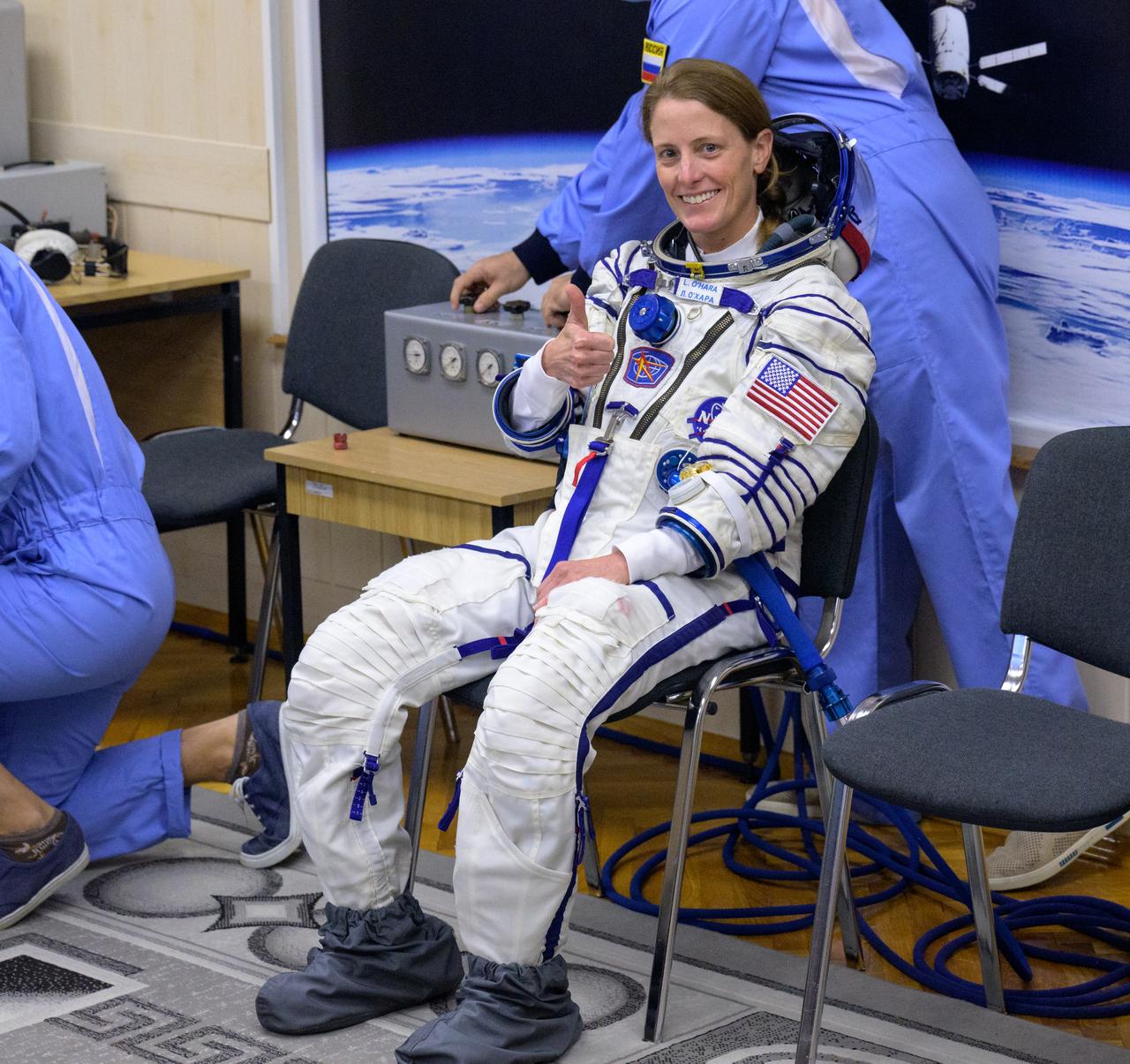 Expedition 70 NASA astronaut Loral O'Hara gives a thumbs up as she and fellow cremates, Roscosmos cosmonauts Oleg Kononenko and Nikolai Chub, have their Russian Sokol Suits pressure checked ahead of their Soyuz launch to the International Space Station Friday, Sept. 15, 2023 in Baikonur, Kazakhstan. The launch will send Expedition 70 NASA astronaut Loral O'Hara and Roscosmos cosmonauts Oleg Kononenko and Nikolai Chub on a mission to the International Space Station. Photo Credit: (NASA/Bill Ingalls)