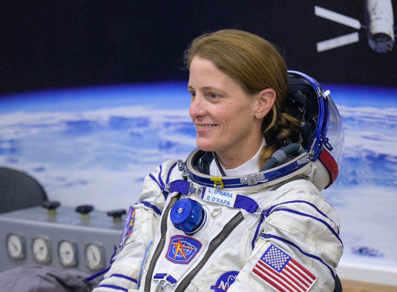 Expedition 70 NASA astronaut Loral O'Hara smiles to family as she and fellow cremates, Roscosmos cosmonauts Oleg Kononenko and Nikolai Chub, have their Russian Sokol Suits pressure checked ahead of their Soyuz launch to the International Space Station Friday, Sept. 15, 2023 in Baikonur, Kazakhstan. The launch will send Expedition 70 NASA astronaut Loral O'Hara and Roscosmos cosmonauts Oleg Kononenko and Nikolai Chub on a mission to the International Space Station. Photo Credit: (NASA/Bill Ingalls)
