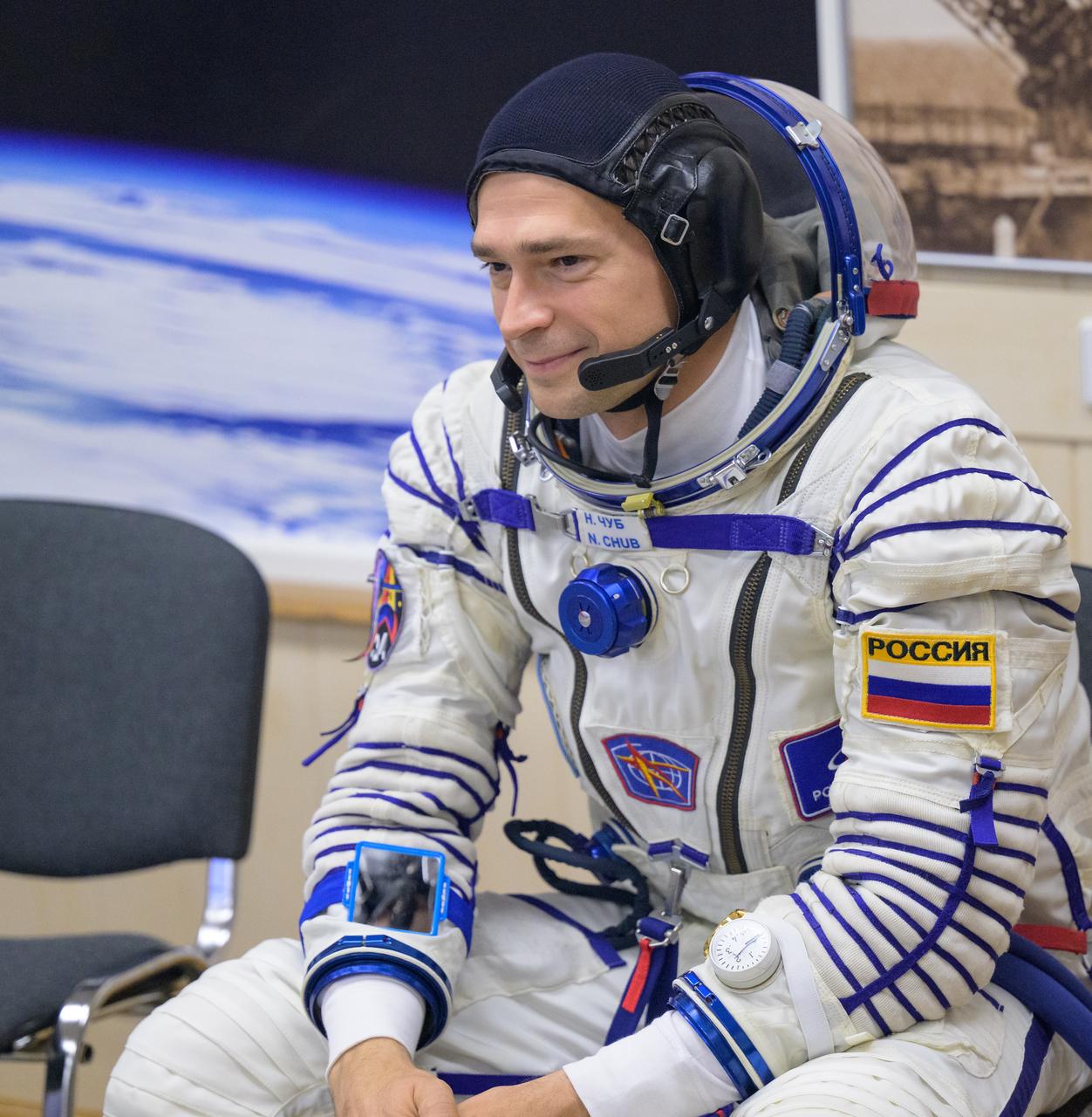 Expedition 70 Roscosmos cosmonaut Nikolai Chub smiles to family as he and fellow cremates, Roscosmos cosmonaut Oleg Kononenko and NASA astronaut Loral O'Hara, have their Russian Sokol Suits pressure checked ahead of their Soyuz launch to the International Space Station Friday, Sept. 15, 2023 in Baikonur, Kazakhstan. The launch will send Expedition 70 NASA astronaut Loral O'Hara and Roscosmos cosmonauts Oleg Kononenko and Nikolai Chub on a mission to the International Space Station. Photo Credit: (NASA/Bill Ingalls)