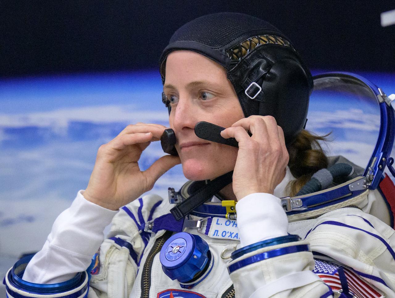 Expedition 70 NASA astronaut Loral O'Hara adjust her cap as she and fellow cremates, Roscosmos cosmonauts Oleg Kononenko and Nikolai Chub, have their Russian Sokol Suits pressure checked ahead of their Soyuz launch to the International Space Station Friday, Sept. 15, 2023 in Baikonur, Kazakhstan. The launch will send Expedition 70 NASA astronaut Loral O'Hara and Roscosmos cosmonauts Oleg Kononenko and Nikolai Chub on a mission to the International Space Station. Photo Credit: (NASA/Bill Ingalls)