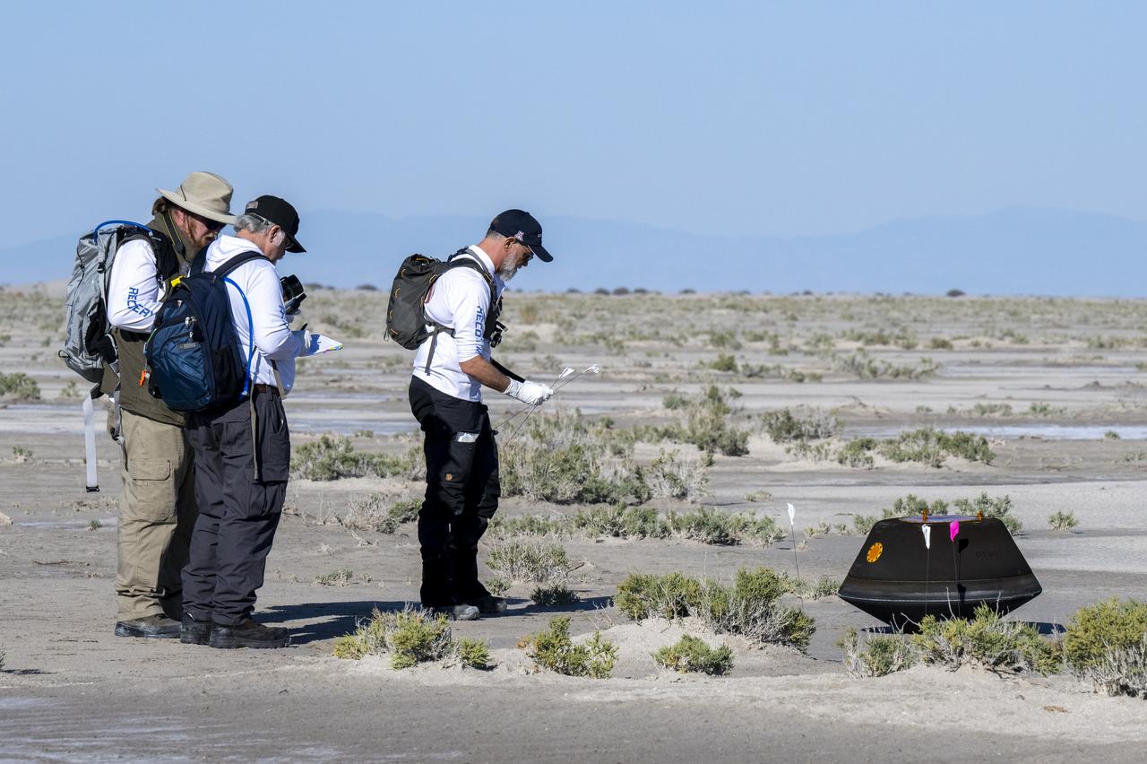 From left to right, NASA Astromatierals Curator Francis McCubbin, NASA Sample Return Capsule Science Lead Scott Sandford, and University of Arizona OSIRIS-REx Principal Investigator Dante Lauretta, collect science data, Sunday, Sept. 24, 2023, shortly after the sample return capsule from NASA’s OSIRIS-REx mission landed at the Department of Defense's Utah Test and Training Range. The sample was collected from the asteroid Bennu in October 2020 by NASA’s OSIRIS-REx spacecraft. Photo Credit: (NASA/Keegan Barber)