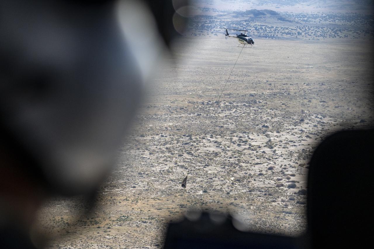 The sample return capsule from NASA’s OSIRIS-REx mission is seen en route to the cleanroom, Sunday, Sept. 24, 2023, shortly after the capsule landed at the Department of Defense's Utah Test and Training Range. The sample was collected from the asteroid Bennu in October 2020 by NASA’s OSIRIS-REx spacecraft. Photo Credit: (NASA/Keegan Barber)
