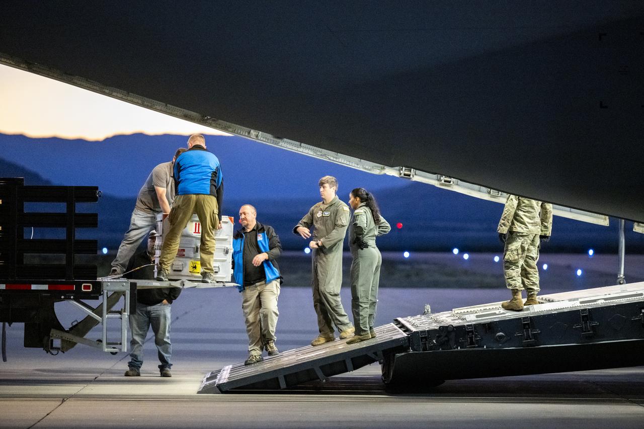 Recovery team members load a container with the science canister from NASA’s OSIRIS-REx mission onto a C-17 Globemaster aircraft, Monday, Sept. 25, 2023, at the Department of Defense's Utah Test and Training Range. The sample was collected from the asteroid Bennu in October 2020 by NASA’s OSIRIS-REx spacecraft. Photo Credit: (NASA/Keegan Barber)