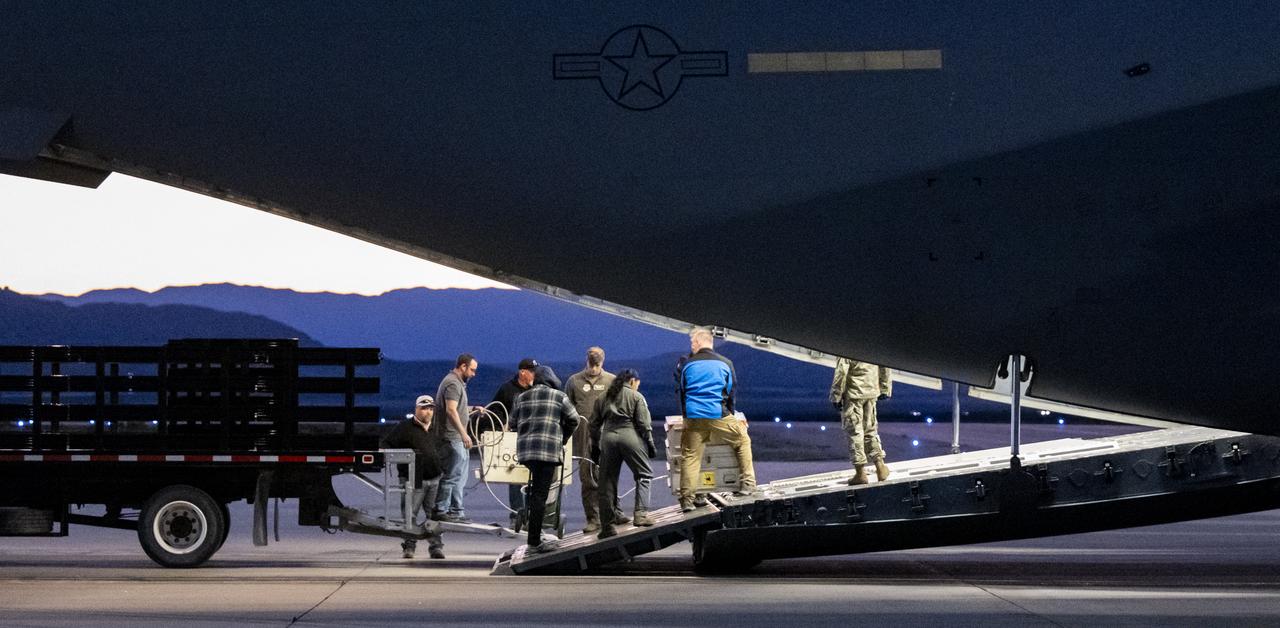 Recovery team members load a container with the science canister from NASA’s OSIRIS-REx mission onto a C-17 Globemaster aircraft, Monday, Sept. 25, 2023, at the Department of Defense's Utah Test and Training Range. The sample was collected from the asteroid Bennu in October 2020 by NASA’s OSIRIS-REx spacecraft. Photo Credit: (NASA/Keegan Barber)