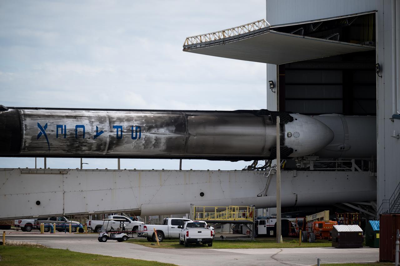 A SpaceX Falcon Heavy rocket with the Psyche spacecraft onboard is seen as it is rolled out of the horizontal integration facility at Launch Complex 39A as preparations continue for the Psyche mission, Tuesday, Oct. 10, 2023, at NASA’s Kennedy Space Center in Florida. NASA’s Psyche spacecraft will travel to a metal-rich asteroid by the same name orbiting the Sun between Mars and Jupiter to study it’s composition. The spacecraft also carries the agency's Deep Space Optical Communications technology demonstration, which will test laser communications beyond the Moon. Photo Credit: (NASA/Aubrey Gemignani)