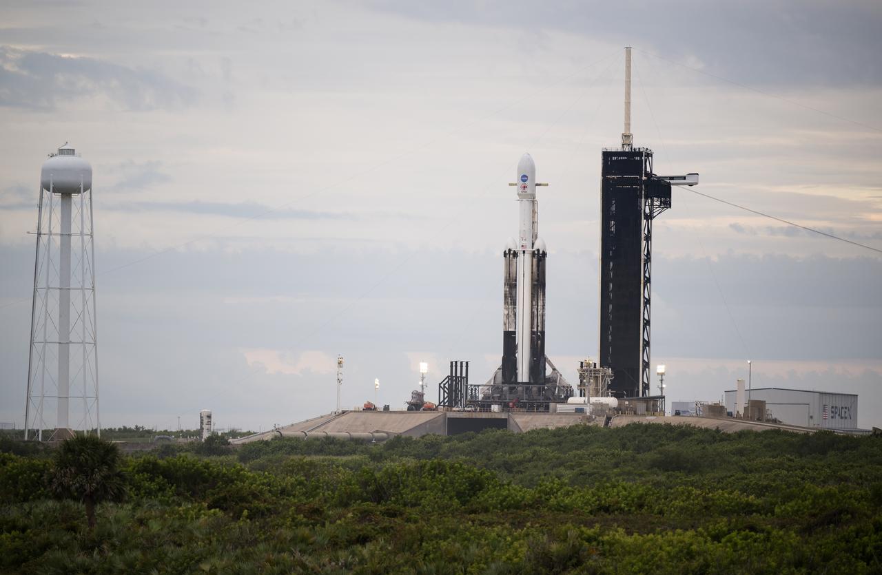 A SpaceX Falcon Heavy rocket with the Psyche spacecraft onboard is seen at Launch Complex 39A as preparations continue for the Psyche mission, Wednesday, Oct. 11, 2023, at NASA’s Kennedy Space Center in Florida. NASA’s Psyche spacecraft will travel to a metal-rich asteroid by the same name orbiting the Sun between Mars and Jupiter to study it’s composition. The spacecraft also carries the agency's Deep Space Optical Communications technology demonstration, which will test laser communications beyond the Moon. Photo Credit: (NASA/Aubrey Gemignani)