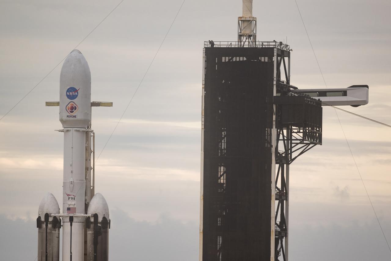 A SpaceX Falcon Heavy rocket with the Psyche spacecraft onboard is seen at Launch Complex 39A as preparations continue for the Psyche mission, Wednesday, Oct. 11, 2023, at NASA’s Kennedy Space Center in Florida. NASA’s Psyche spacecraft will travel to a metal-rich asteroid by the same name orbiting the Sun between Mars and Jupiter to study it’s composition. The spacecraft also carries the agency's Deep Space Optical Communications technology demonstration, which will test laser communications beyond the Moon. Photo Credit: (NASA/Aubrey Gemignani)
