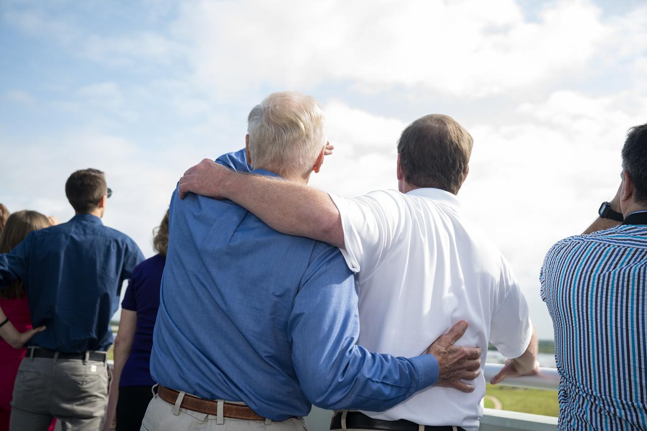 NASA Administrator Bill Nelson and his son Bill Nelson Jr. watch the launch of a SpaceX Falcon Heavy rocket with the Psyche spacecraft onboard from Launch Complex 39A, Friday, Oct. 13, 2023, at NASA’s Kennedy Space Center in Florida. NASA’s Psyche spacecraft will travel to a metal-rich asteroid by the same name orbiting the Sun between Mars and Jupiter to study it’s composition. The spacecraft also carries the agency's Deep Space Optical Communications technology demonstration, which will test laser communications beyond the Moon. Photo Credit: (NASA/Aubrey Gemignani)