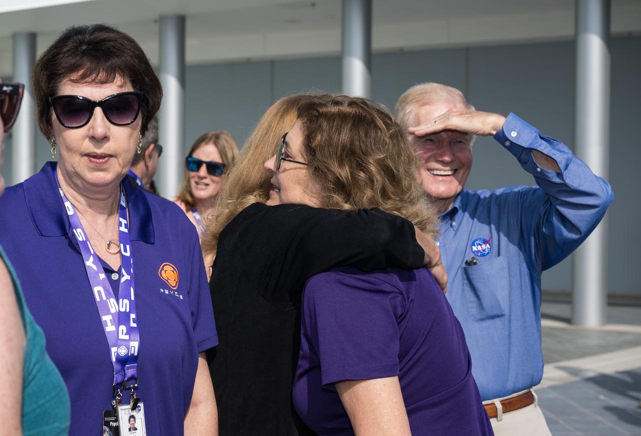 NASA Headquarters Planetary Science Division director Lori Glaze, left, hugs Jet Propulsion Laboratory director Laurie Leshin as NASA Administrator Bill Nelson, right, and Associate Administrator, NASA’s Science Mission Directorate, Nicola Fox watch for the return of the boosters after the launch of a SpaceX Falcon Heavy rocket with the Psyche spacecraft onboard from Launch Complex 39A, Friday, Oct. 13, 2023, at NASA’s Kennedy Space Center in Florida. NASA’s Psyche spacecraft will travel to a metal-rich asteroid by the same name orbiting the Sun between Mars and Jupiter to study it’s composition. The spacecraft also carries the agency's Deep Space Optical Communications technology demonstration, which will test laser communications beyond the Moon. Photo Credit: (NASA/Aubrey Gemignani)