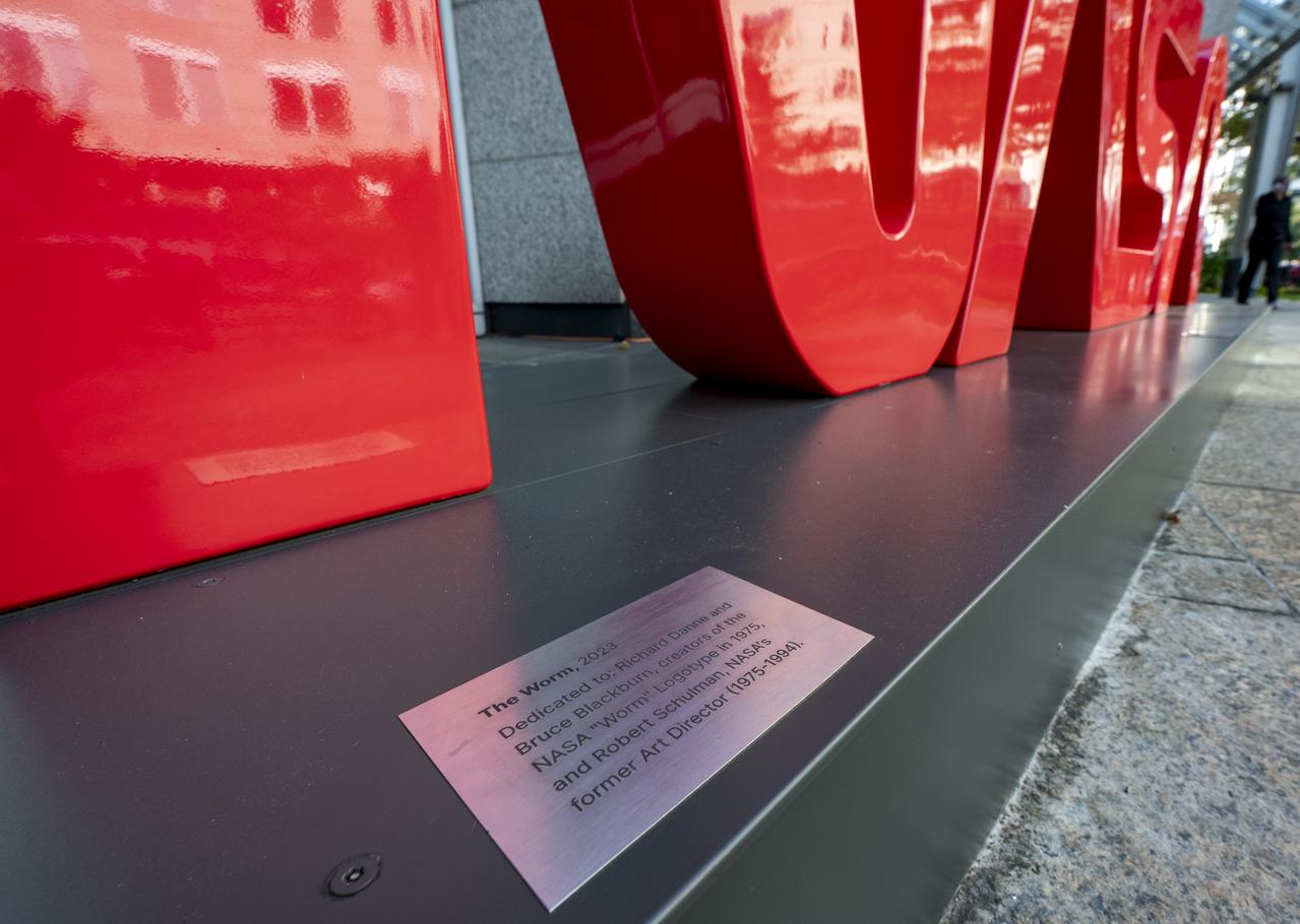A plaque is seen at the base of the NASA Worm Logo sign during a Richard Danne dedication event, Monday, Nov. 6, 2023, at the Mary W. Jackson NASA Headquarters building in Washington. Photo Credit: (NASA/Keegan Barber)
