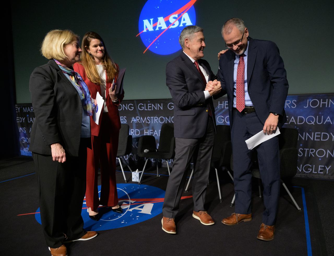NASA Associate Administrator Bob Cabana, 3rd from left, shakes hands with Incoming NASA Associate Administrator Jim Free, right, as NASA Deputy Administrator Pam Melroy, left, and NASA Deputy Associate Administrator Casey Swails look on at the conclusion of a NASA town hall event, Tuesday, Dec. 12, 2023, at the NASA Headquarters Mary W. Jackson Building in Washington. Photo Credit: (NASA/Bill Ingalls)