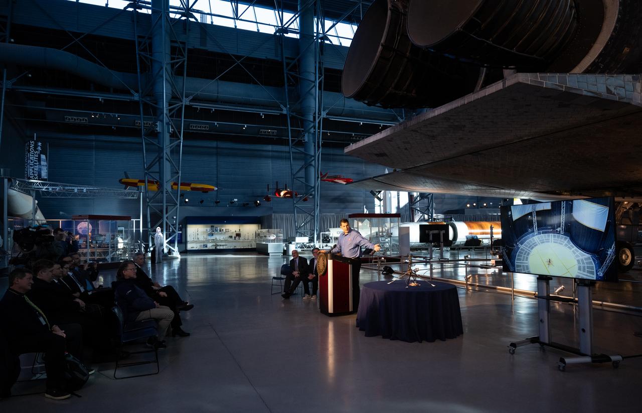 Teddy Tzanetos, Ingenuity project manager at NASA's Jet Propulsion Laboratory speaks at an event marking NASA’s donation of the aerial prototype of the Ingenuity Mars Helicopter, Friday, Dec. 15, 2023, at the Smithsonian National Air and Space Museum’s Steve F. Udvar-Hazy Center in Chantilly, Va. The aerial prototype of the Ingenuity Mars Helicopter, which was the first to demonstrate it was possible to fly in a simulated Mars environment at NASA’s Jet Propulsion Laboratory (JPL), was donated to the museum on Friday.  Photo Credit: (NASA/Joel Kowsky)