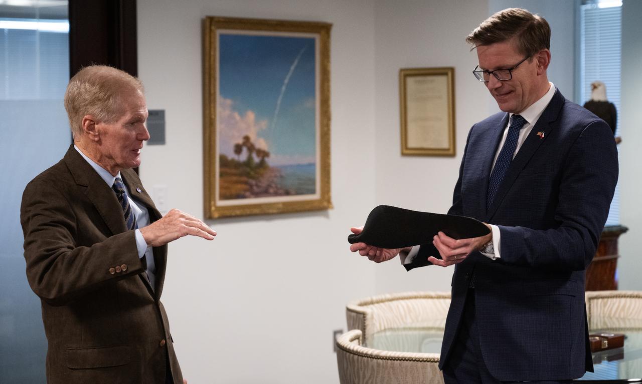 NASA Administrator Bill Nelson, left, speaks with Martin Kupka, Minister of Transport for the Czech Republic, about the Mars Helicopter Ingenuity as he holds a rotor blade representative of the one on the craft on Mars during a meeting at the Mary W. Jackson NASA Headquarters building, Monday, Jan. 22, 2024, in Washington. Photo Credit: (NASA/Joel Kowsky)