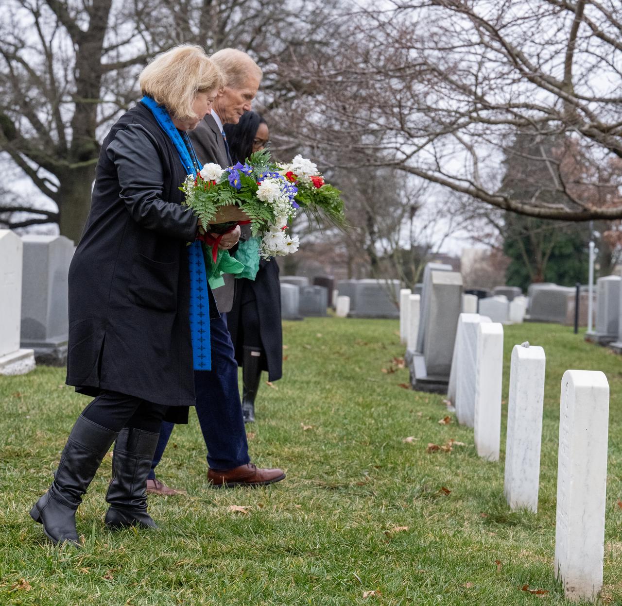 NASA Administrator Bill Nelson and NASA Deputy Administrator Pam Melroy place flowers at the grave markers of Virgil "Gus" Grissom and Roger Chaffee from Apollo 1, during a ceremony that was part of NASA's Day of Remembrance, Thursday, Jan. 25, 2024, at Arlington National Cemetery in Arlington, Va. The wreaths were laid in memory of those men and women who lost their lives in the quest for space exploration. Photo Credit: (NASA/Keegan Barber)