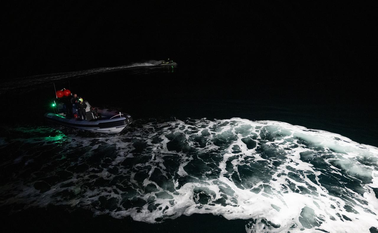 A fast boat and a jet ski is seen with members of the SpaceX support team is seen after being deployed from the SpaceX recovery ship MEGAN in the Gulf of Mexico as the recovery team prepares for the landing of the SpaceX Dragon spacecraft with NASA astronaut Jasmin Moghbeli, ESA (European Space Agency) astronaut Andreas Mogensen, Japan Aerospace Exploration Agency (JAXA) astronaut Satoshi Furukawa, and Roscosmos cosmonaut Konstantin Borisov aboard, Tuesday, March 12, 2024, off the coast of Pensacola, Florida. Moghbeli, Mogensen, Furukawa, and Borisov are returning after nearly six-months days in space as part of Expedition 70 aboard the International Space Station. Photo Credit: (NASA/Joel Kowsky)