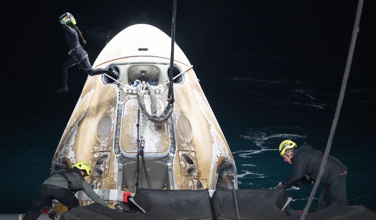 Support teams work around the SpaceX Dragon Endurance spacecraft shortly after it landed with NASA astronaut Jasmin Moghbeli, ESA (European Space Agency) astronaut Andreas Mogensen, Japan Aerospace Exploration Agency (JAXA) astronaut Satoshi Furukawa, and Roscosmos cosmonaut Konstantin Borisov aboard in the Gulf of Mexico off the coast of Pensacola, Florida, Tuesday, March 12,2024. Moghbeli, Mogensen, Furukawa, and Borisov are returning after nearly six-months in space as part of Expedition 70 aboard the International Space Station. Photo Credit: (NASA/Joel Kowsky)