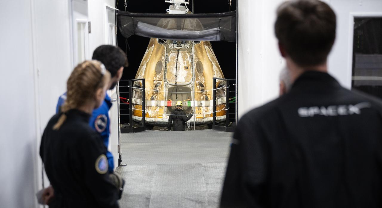 Members of the medical teams watch as the SpaceX Dragon Endurance spacecraft is moved aboard the recovery ship MEGAN shortly after it landed with NASA astronaut Jasmin Moghbeli, ESA (European Space Agency) astronaut Andreas Mogensen, Japan Aerospace Exploration Agency (JAXA) astronaut Satoshi Furukawa, and Roscosmos cosmonaut Konstantin Borisov aboard in theGulf of Mexico off the coast of Pensacola, Florida, Tuesday, March 12, 2024. Moghbeli, Mogensen, Furukawa, and Borisov are returning after nearly six-months in space as part of Expedition 70 aboard the International Space Station. Photo Credit: (NASA/Joel Kowsky)