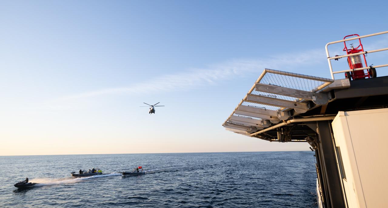 The helicopter that will carry cargo and support personnel back to shore is seen as it approaches the SpaceX recovery ship MEGAN in the Gulf of Mexico off the coast of Pensacola, Florida, Tuesday, March 12, 2024. Moghbeli, Mogensen, Furukawa, and Borisov are returning after nearly six-months in space as part of Expedition 70 aboard the International Space Station. Photo Credit: (NASA/Joel Kowsky)