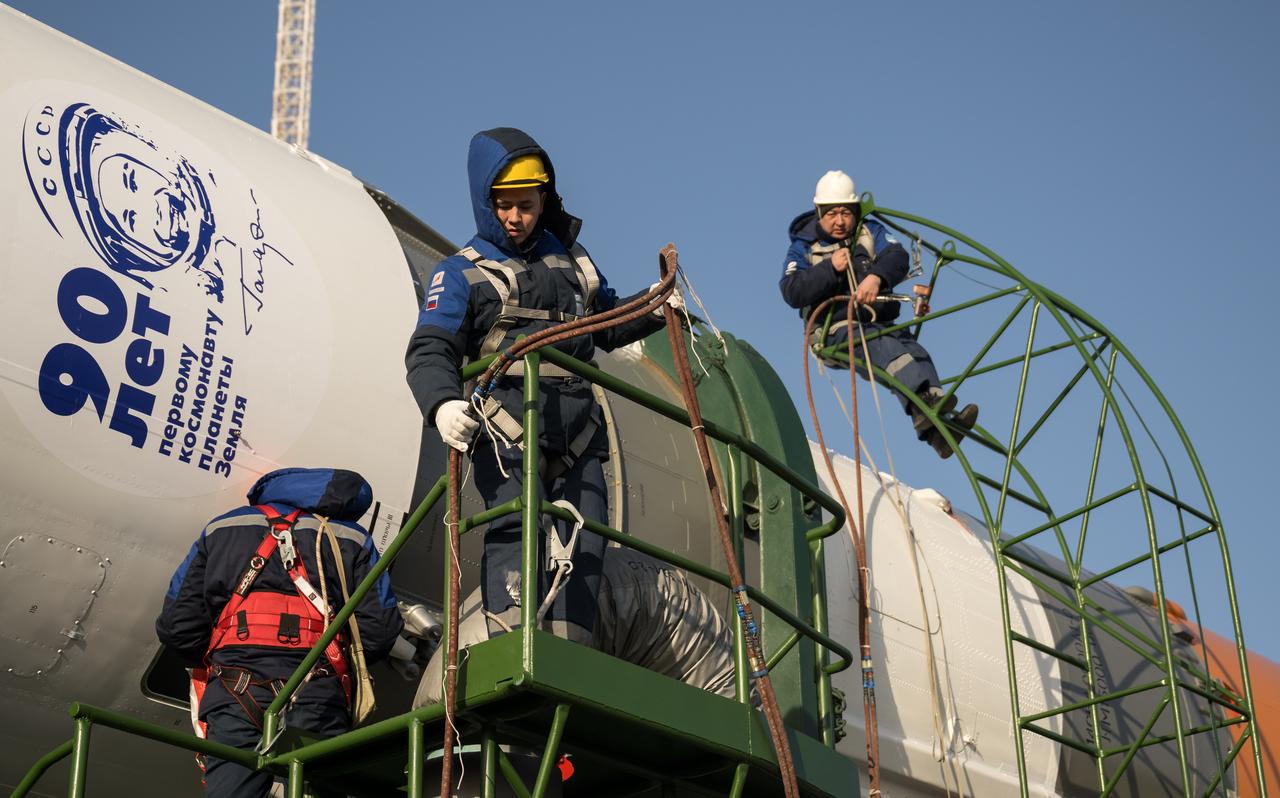 Technicians work on the Soyuz rocket after it is rolled out by train to the launch pad at Site 31, Monday, March 18, 2024, at the Baikonur Cosmodrome in Kazakhstan. Expedition 71 NASA astronaut Tracy Dyson, Roscosmos cosmonaut Oleg Novitskiy, and Belarus spaceflight participant Marina Vasilevskaya are scheduled to launch aboard their Soyuz MS-25 spacecraft on March 21. Photo Credit: (NASA/Bill Ingalls)