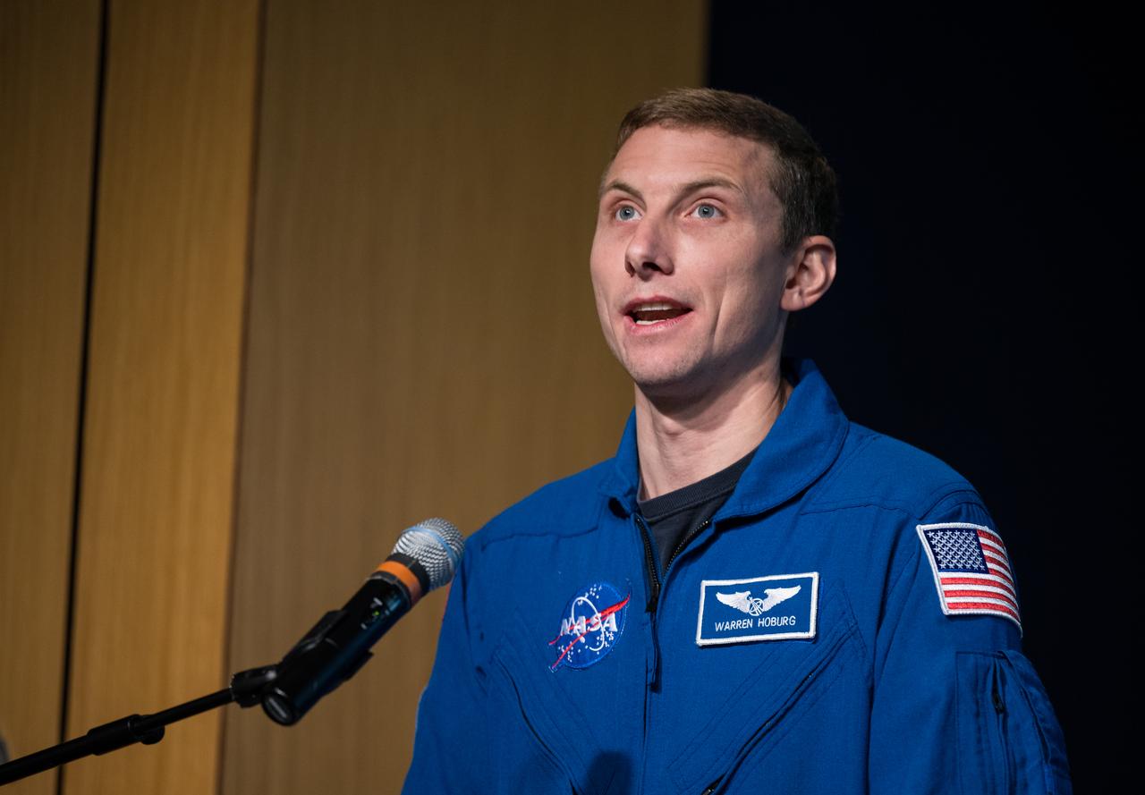 Expedition 69 NASA astronaut Warren Hoburg describes the Silver Snoopy award after he and fellow crewmates NASA astronauts Frank Rubio and Stephen Bowen, and UAE (United Arab Emirates) astronaut Sultan Alneyadi spoke about their time aboard the International Space Station as part of Expedition 69 during an employee engagement event Tuesday, March 19, 2024, at the Mary W. Jackson NASA Headquarters building in Washington.  Bowen, Hoburg, and Alneyadi spent 186 days aboard the International Space Station as part of Expedition 69; while Rubio set a new record for the longest single spaceflight by a U.S. astronaut, spending 371 days in orbit on an extended mission spanning Expeditions 68 and 69. Photo Credit: (NASA/Aubrey Gemignani)