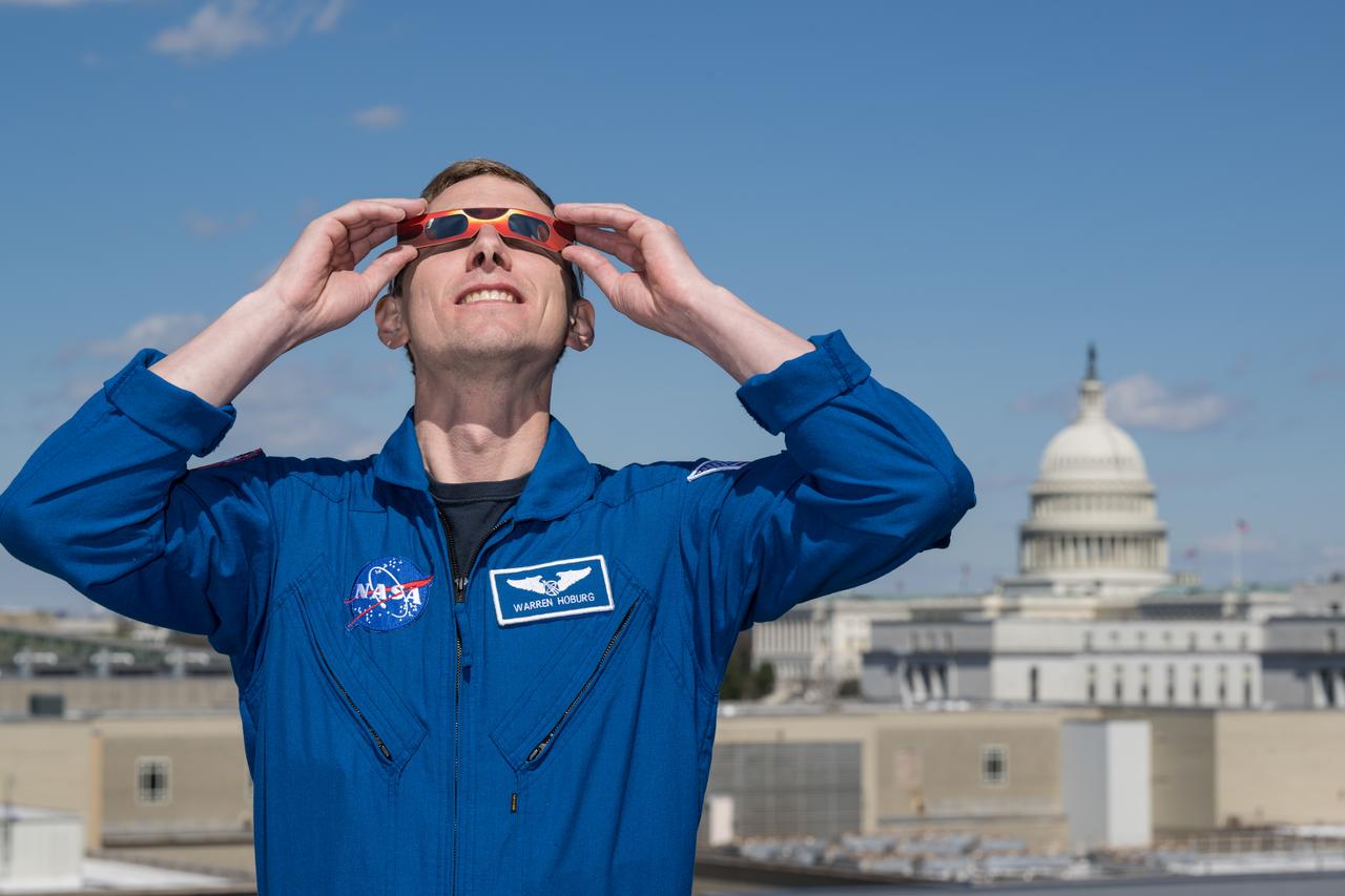 NASA astronaut Warren Hoburg poses for a photo wearing solar glasses, Tuesday, March 19, 2024, at the Mary W. Jackson NASA Headquarters building in Washington. Hoburg and Expedition 69 crewmates NASA astronaut Stephen Bowen, and UAE (United Arab Emirates) astronaut Sultan Alneyadi spent 186 days aboard the International Space Station as part of Expedition 69; while NASA astronaut Frank Rubio set a new record for the longest single spaceflight by a U.S. astronaut, spending 371 days in orbit on an extended mission spanning Expeditions 68 and 69. Photo Credit: (NASA/Aubrey Gemignani)