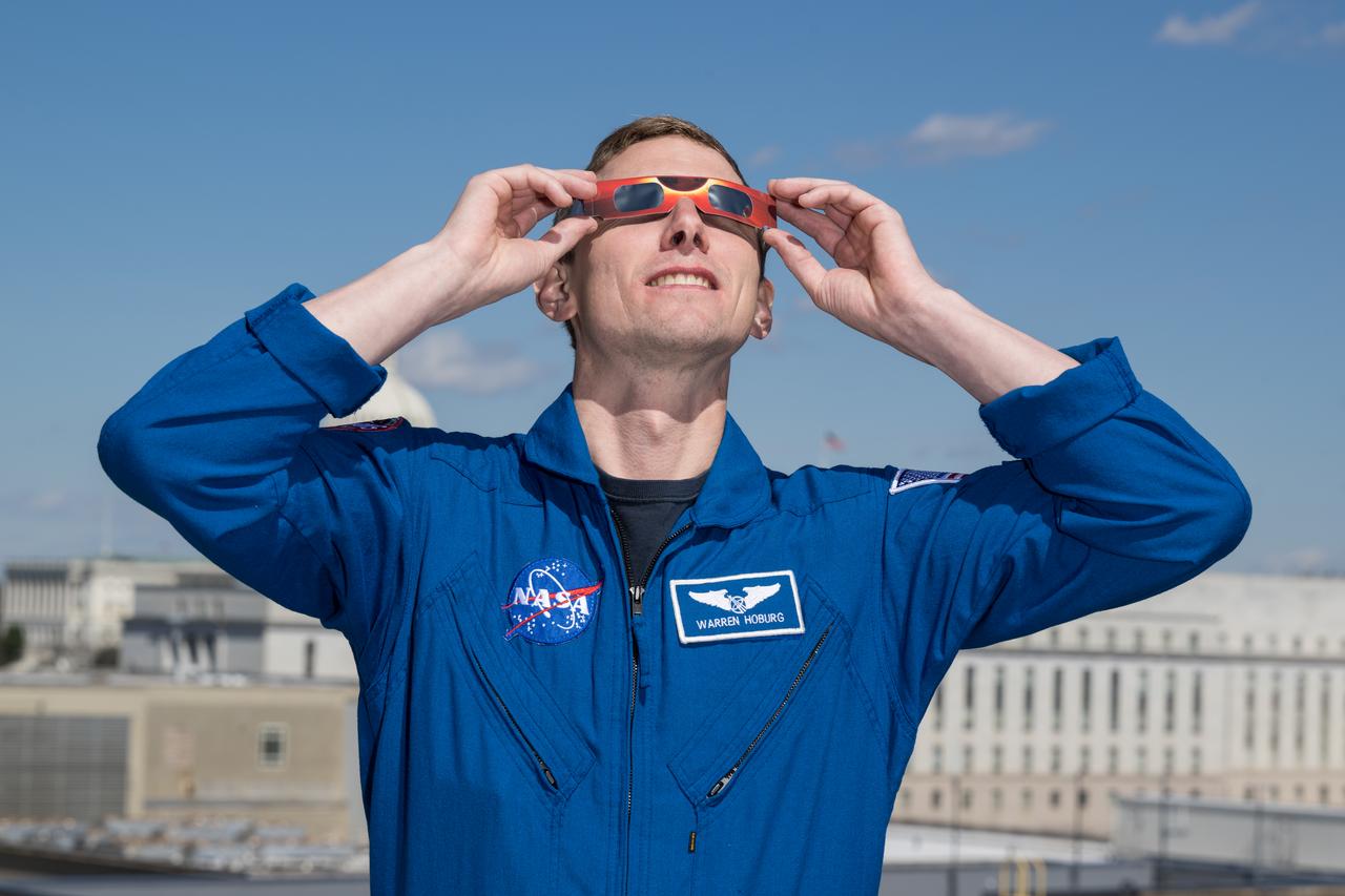 NASA astronaut Warren Hoburg poses for a photo wearing solar glasses, Tuesday, March 19, 2024, at the Mary W. Jackson NASA Headquarters building in Washington. Hoburg and Expedition 69 crewmates NASA astronaut Stephen Bowen, and UAE (United Arab Emirates) astronaut Sultan Alneyadi spent 186 days aboard the International Space Station as part of Expedition 69; while NASA astronaut Frank Rubio set a new record for the longest single spaceflight by a U.S. astronaut, spending 371 days in orbit on an extended mission spanning Expeditions 68 and 69. Photo Credit: (NASA/Aubrey Gemignani)