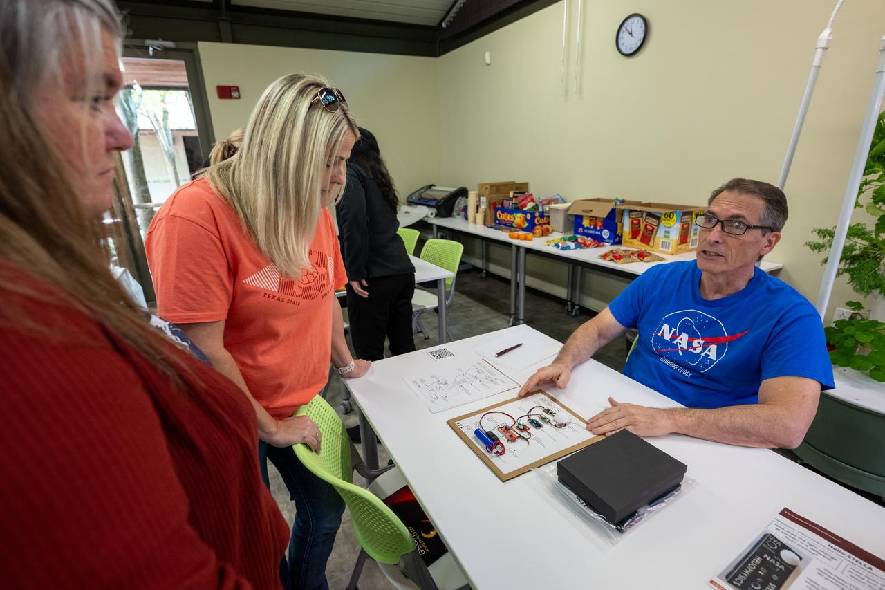 NASA Heliophysics Science Division Instrument Systems Engineer Patrick Haas, right, demonstrates heliophysics activities during a teacher professional development event hosted by the NASA Heliophysics Education Activation Team (HEAT) at the Dallas Arboretum, Saturday, April 6, 2024, in Dallas, Texas. Photo Credit: (NASA/Keegan Barber)