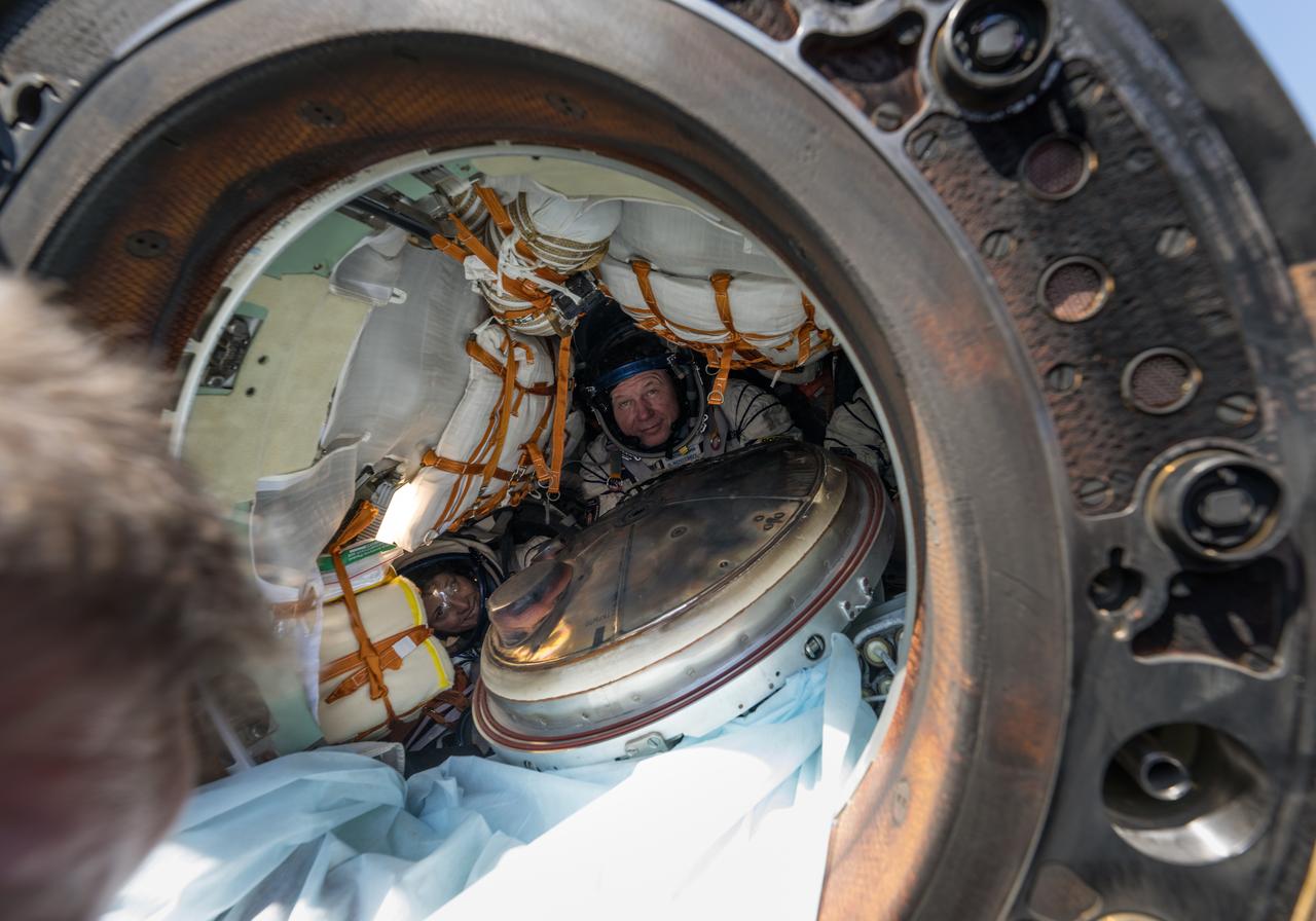 Expedition 70 NASA astronaut Loral O'Hara, left, and Roscosmos cosmonaut Oleg Novitskiy, are seen inside the Soyuz MS-24 spacecraft just minutes after they and Belarus spaceflight participant Marina Vasilevskaya, landed in a remote area near the town of Zhezkazgan, Kazakhstan on Saturday, April 6, 2024. O’Hara is returning to Earth after logging 204 days in space as a member of Expeditions 69-70 aboard the International Space Station and Novitskiy and Vasilevskaya return after having spent the last 14 days in space. Photo Credit (NASA/Bill Ingalls)